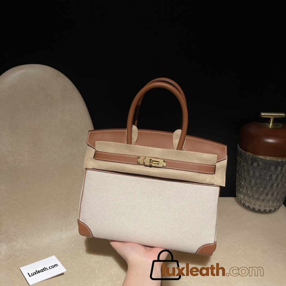 Hermès Birkin 30 (Swift Leather & Canvas) – Color: 37/Gold with Gold Hardware The attractive fusion of Swift leather and canvas creates an elegant vintage style – a rare model with great collector value.